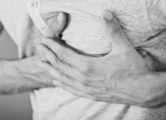 12 Best Fruits For The Heart A picture of a man holding his left chest region