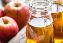 Benefits and Side Effects of Apple Juice A picture of apples and some apple cider vinegar