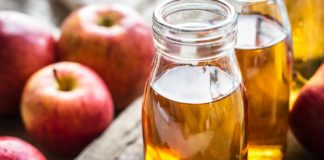 Dangerous Side Effects of Apple Cider Vinegar A picture of apples and some apple cider vinegar