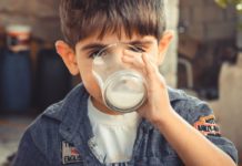 Causes, Symptoms, and Treatment of Lactose Intolerance A boy drinking buttermilk