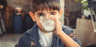 Causes, Symptoms, and Treatment of Lactose Intolerance A boy drinking buttermilk
