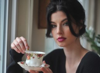 9 Green Tea Benefits for Weight Loss A woman holding a cup of tea