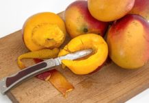 Health Benefits of Mango Leaves Tea Mangoes on a chopping board