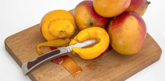 Health Benefits of Mango Leaves Tea Mangoes on a chopping board