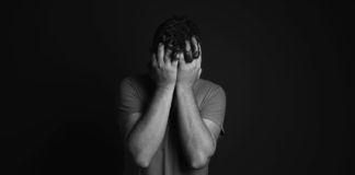 Know Your Mental Health A man with his head in his hands